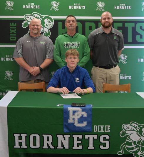 Hunter with coaches behind him