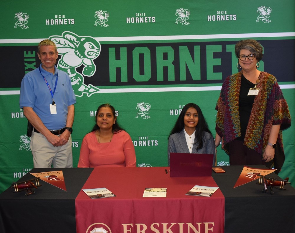Harvee, her mom, Mrs. McKinsey, and Mr. Prescott at the signing