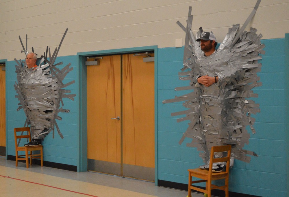 mr. ramey and coach botts duct taped to wall
