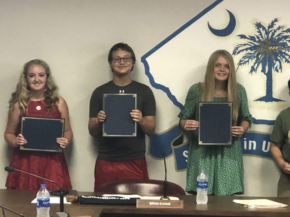 Ryleigh, Daniel, and Kate hold their certificates.