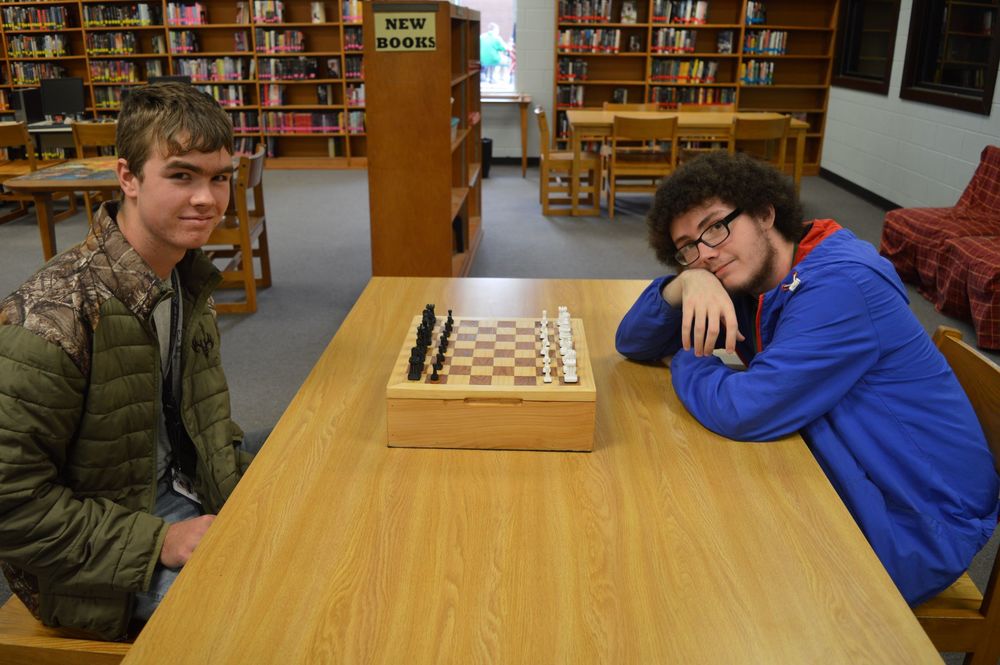 Students posing with their chess board
