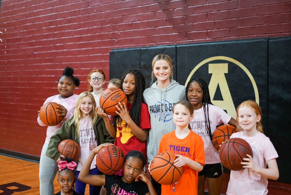 students posing for a picture with basketballs
