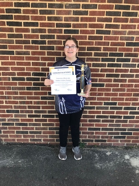 Madison holding her trophy and certificate