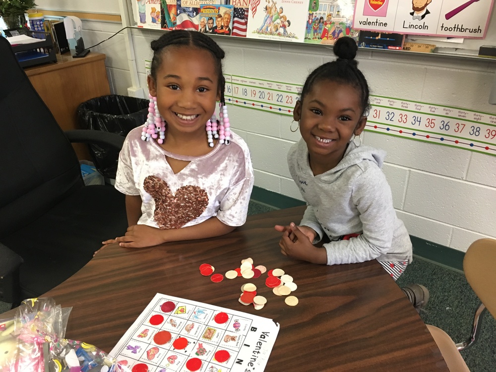 Second grade student and K5 Student playing valentine's bingo