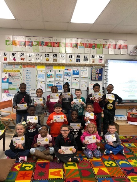 Group of students in classroom with All-star certificates