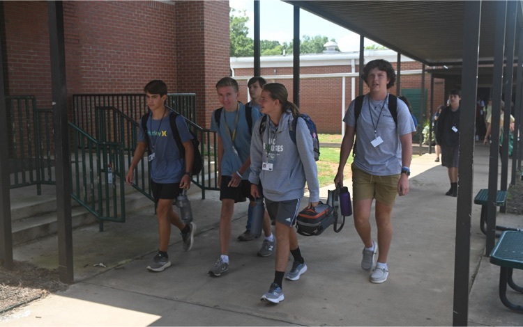 students walking down breezeway 