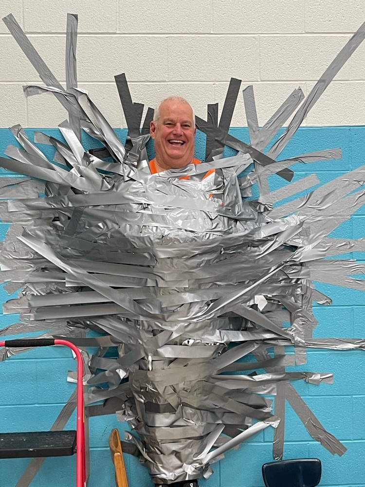 mr. Ramey taped to a wall